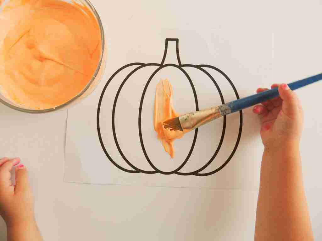 Painting a pumpkin for halloween